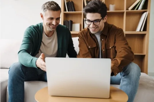 Couple engaged in online therapy session at computer