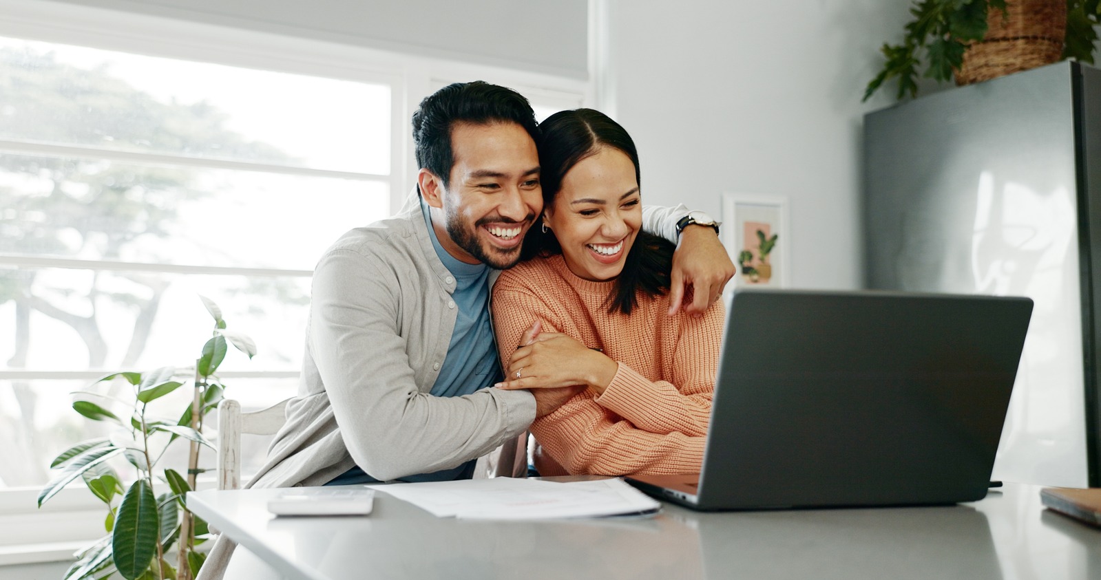 Couple engaged in online therapy session at computer