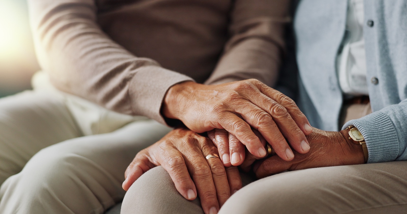 Intimate moment of couple holding hands during therapy